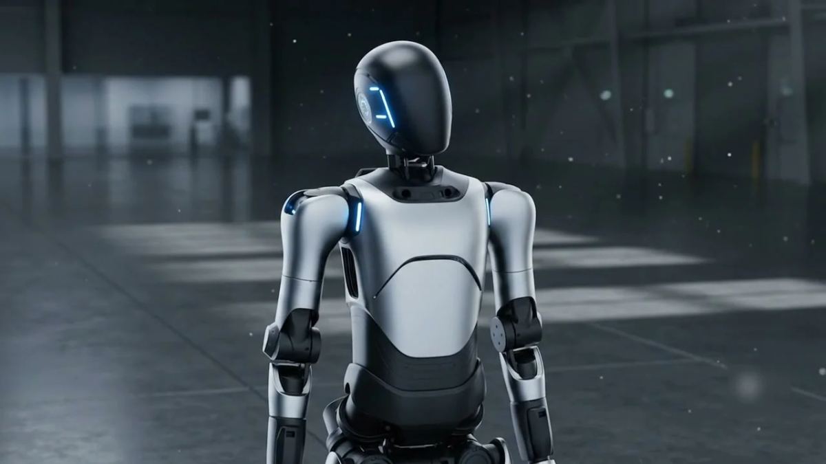 Humanoid robot walking through a dim industrial facility