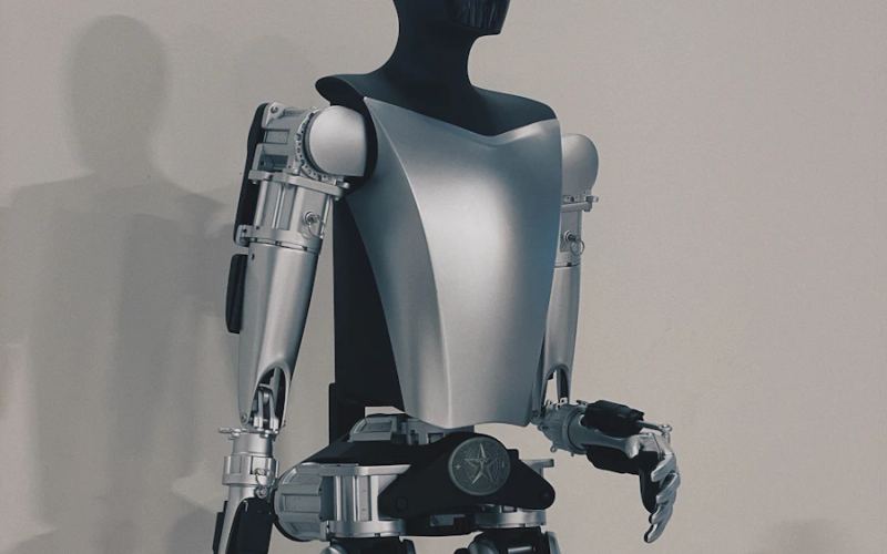 Humanoid robot torso and arms in an industrial setting
